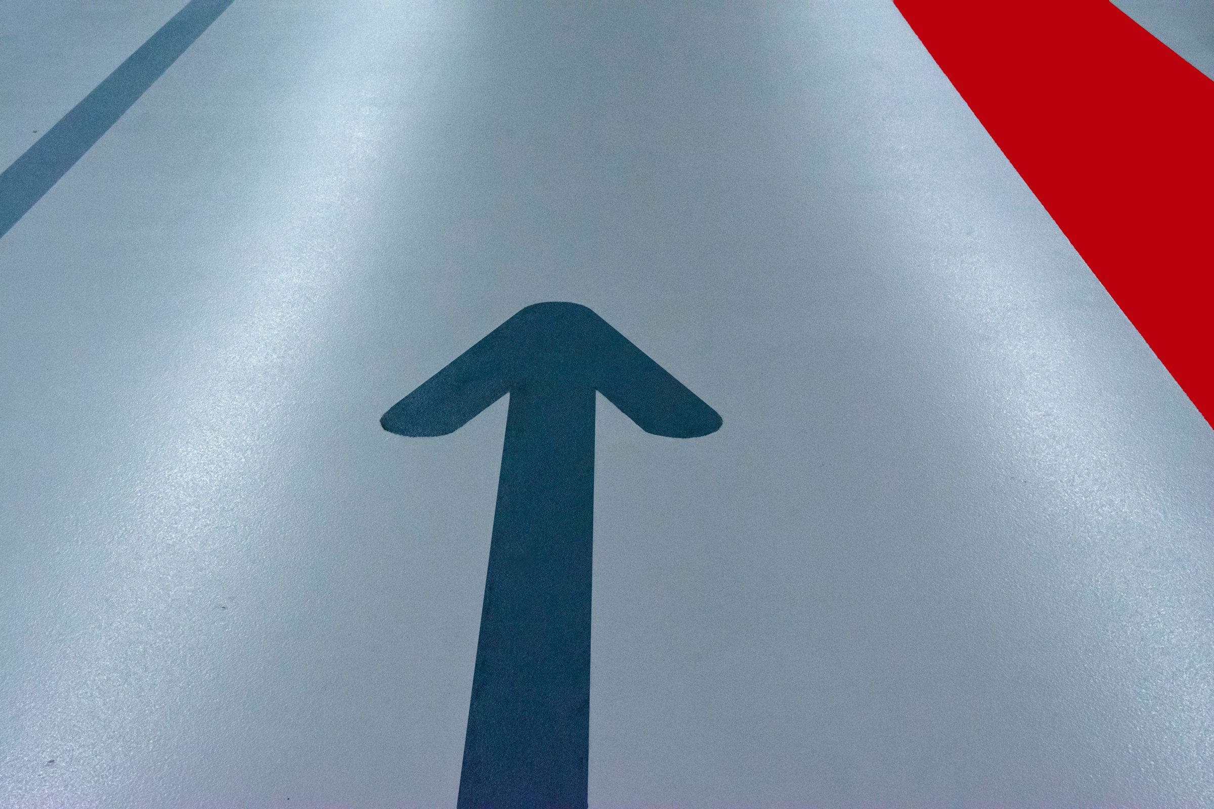 Coated commercial parking deck floor with directional markings