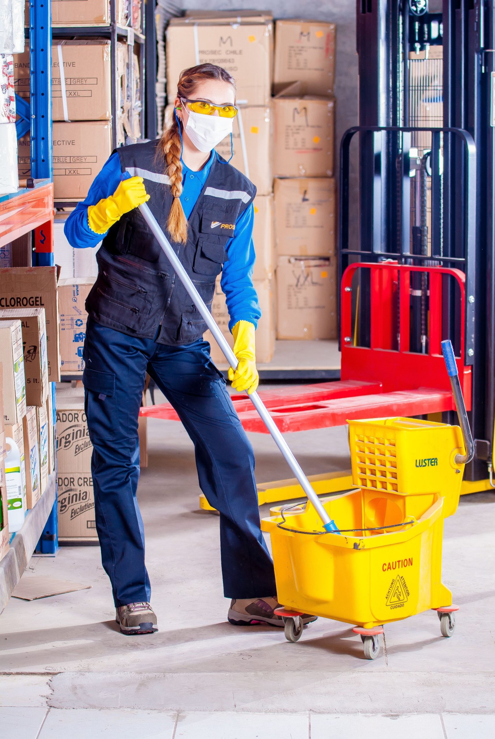 Worker cleaning a commercial warehouse floor