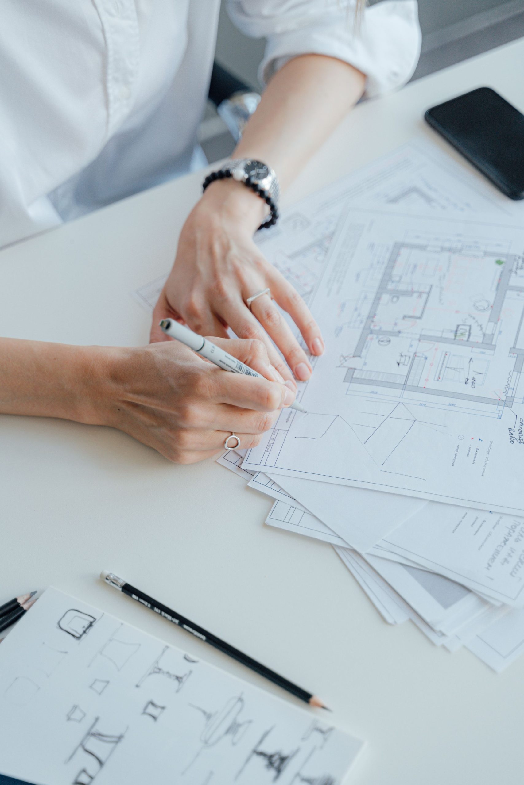 Architect writing on floor plans for commercial flooring planning