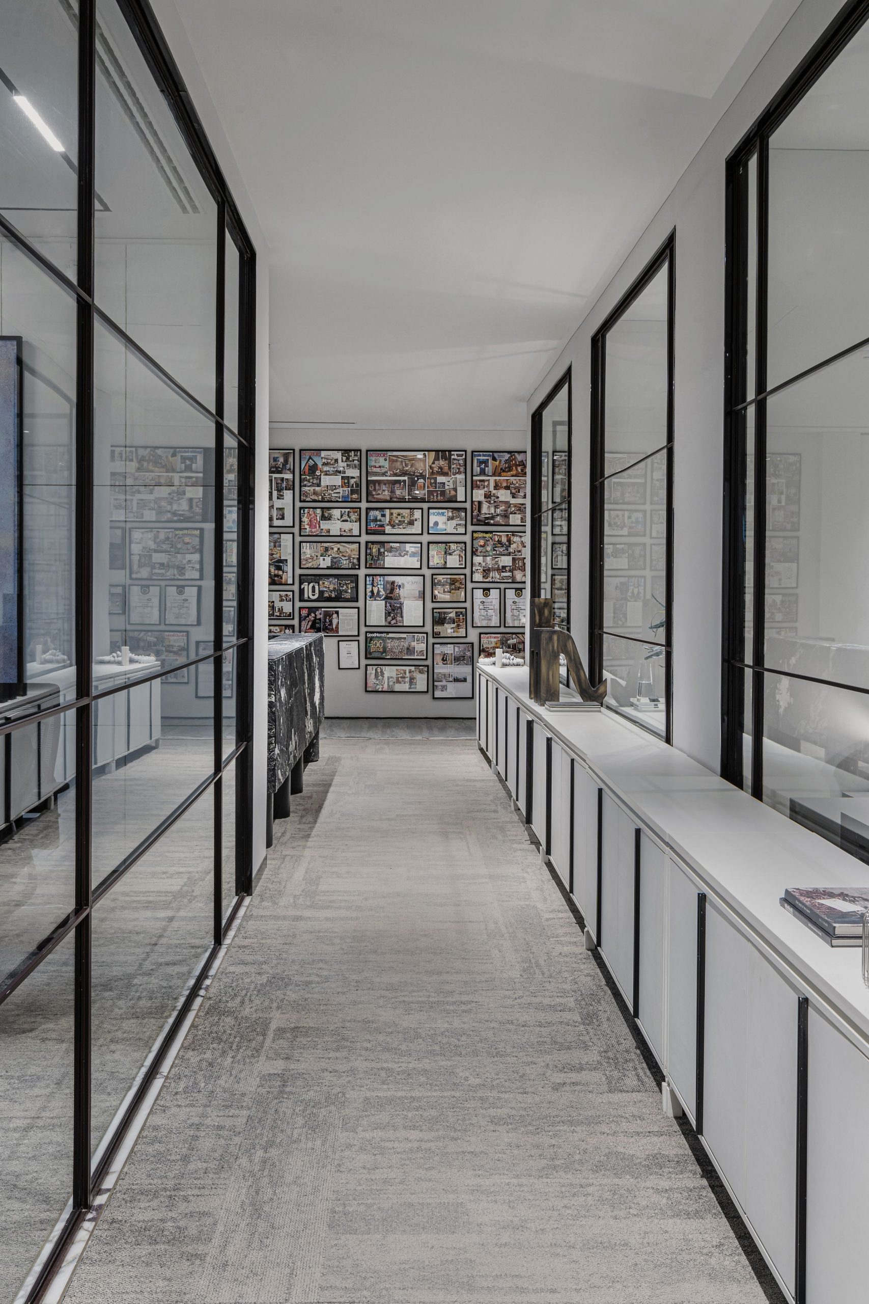 Commercial corridor with carpet and glass partitions