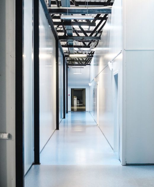Commercial facility corridor with durable flooring and glass doors